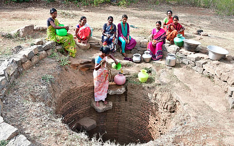 The main source of water here is a muddy open well that provides four to five pots of water per family each day.