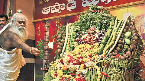 The idol of Kanaka Durga decorated with vegetables as a priest offers harati to the Goddess on Day 1 of the Shakambari festival in Vijayawada.