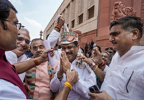 Former Union Education Minister Dharmendra Pradhan being greeted during the Monsoon session of Parliament, in New Delhi, Monday, July 27, 2026.