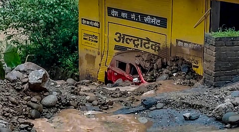 A vehicle damaged and buried under debris following a landslide after heavy rainfall, in Chamba, Himachal Pradesh, Tuesday, July 28, 2026.