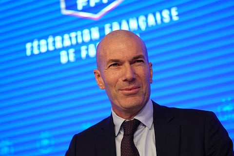 Zinedine Zidane, newly appointed coach of the France national soccer team, smiles during a media conference at the headquarters of French Football Federation headquarters in Paris.