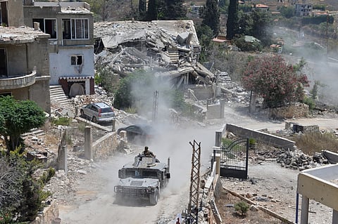 A Lebanese military vehicle drives past homes damaged during the war in the southern village of Zawtar al-Gharbieh, Lebanon, Monday, July 27, 2026.