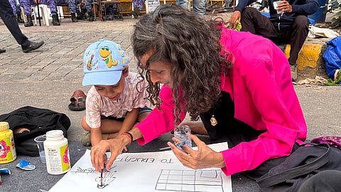 Poet, storyteller Harshit Singh (left) at the letter-writing workshop organised for kids at the protest site