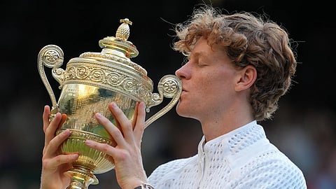 Jannik Sinner of Italy kisses the winners trophy after defeating Alexander Zverev of Germany in the men's singlesfinal at Wimbledon Tennis Championships in London, Sunday, July 12, 2026.