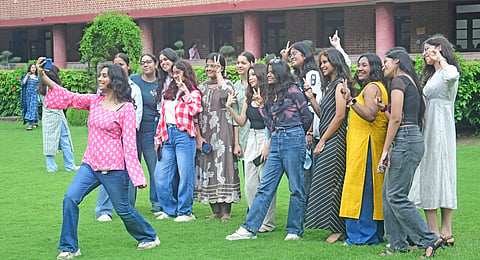 Freshers socialise with one another on the first day of the new academic session of Delhi University on Tuesday.