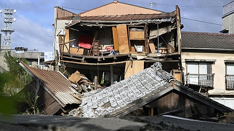 The roof and wall of a building are seen fallen, a day after an earthquake in Yatsushiro, Kumamoto prefecture, Wednesday, July 29, 2026.