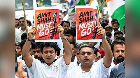 Indian Youth Congress workers stage a protest, demanding the resignation of Union Home Minister Amit Shah, at Jantar Mantar in New Delhi on Thursday, July 30, 2026.