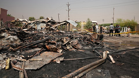 Iraqis inspect damaged structures at the site of an airstrike on a Popular Mobilization Forces base in Mosul, Iraq, Wednesday, July 29, 2026.