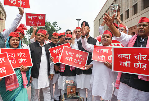 Samajwadi Party chief Akhilesh Yadav and other SP MPs stage a protest at the Makar Dwar, carrying placards and raising slogans over alleged financial irregularities concerning the Ram Temple funds, during the ongoing Monsoon Session of Parliament, in New Delhi on Wednesday.