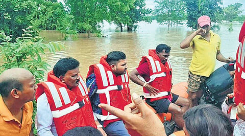 Officials rescuing marooned villagers from flood-hit Belkhandi in Kesinga block