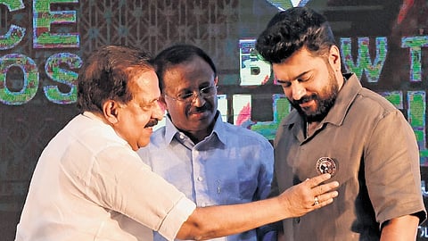 Home Minister Ramesh Chennithala presenting a Vigilance Commando’s badge to actor Nivin Pauly during the launch of an anti-corruption campaign at Loyola School, Thiruvananthapuram. MLA V Muraleedharan is also seen.