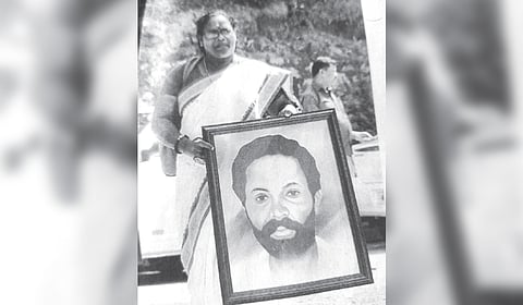 C K Janu with a portrait of tribal protester Jogi, whose case has never been investigated.