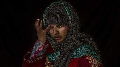 Insha Mushtaq poses for a portrait inside her home.