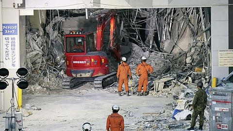 Heavy machinery removes debris at AEON Mall, which was damaged by an explosion following an earthquake, in Kashima, Kumamoto Prefecture, southern Japan, Friday, July 31, 2026.