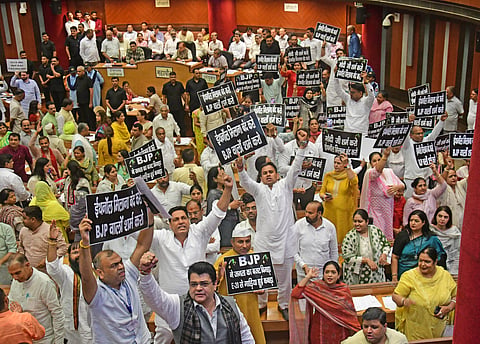 Opposition councillors protest during a house meeting on Thursday.