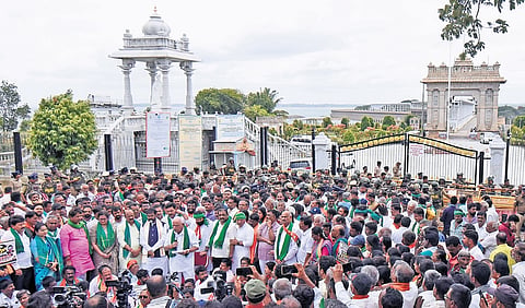 BJP leaders and workers protest at the gates of the Krishna Raja Sagar reservoir in Srirangapatna taluk of Mandya district on Friday