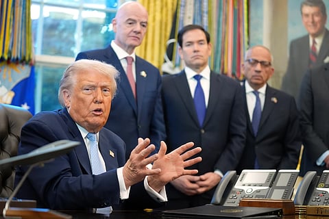 President Donald Trump answers questions from reporters during a meeting with the White House task force on the 2026 FIFA World Cup in the Oval Office of the White House, Monday, Nov. 17, 2025, in Washington, as FIFA President Gianni Infantino, Secretary of State Marco Rubio and FIFA senior adviser Carlos Cordeiro listen.