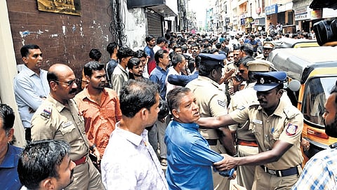 Traders gather on Mint Street against the inspection by GST team, alleging that it was being conducted unlawfully.