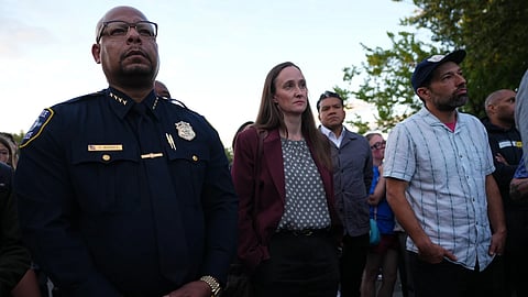 Seattle Mayor Katie Wilson, center, and Seattle Police Chief Shon Barnes, left, attend the vigil for victims the day after a shooting at Seattle Center during the Bite of Seattle food festival, Monday, July 27, 2026.