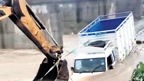A mini truck stuck in floodwaters in Komaram Bheem Asifabad