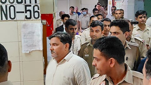 AAP councillor Tahir Hussain being escorted by police personnel as he leaves after a hearing in the case of the murder of Intelligence Bureau officer Ankit Sharma during the 2020 Delhi riots, at the Karkardooma Court, in New Delhi, Friday, July 31, 2026.