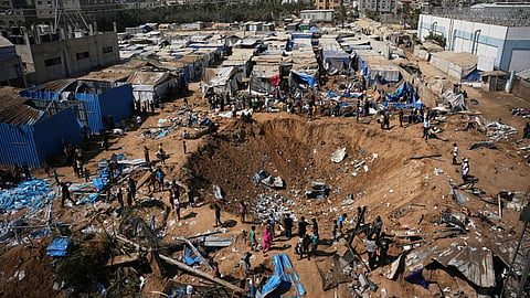 Palestinians inspect the scene of an Israeli airstrike near al-Aqsa Hospital in Deir al-Balah in the central Gaza Strip, Saturday, Aug. 1, 2026.