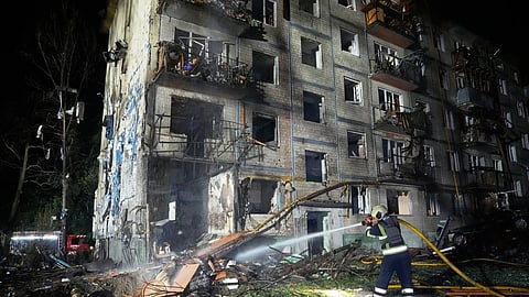 Emergency services personnel work to extinguish a fire following Russian missile attacks in Kyiv, Ukraine, Saturday, August 1, 2026.