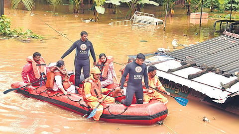 Fire and Rescue Services personnel evacuate residents after floodwaters entered their homes following heavy rain in Ranni town, Pathanamthitta.
