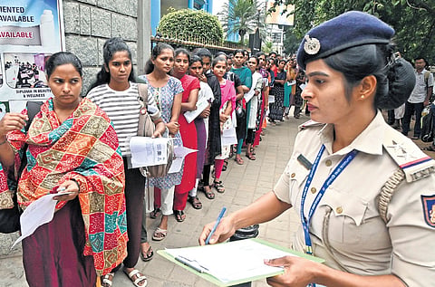 Candidates wait to enter the exam hall at St Joseph's Indian High School
in Bengaluru on Sunday, August 2, 2026.