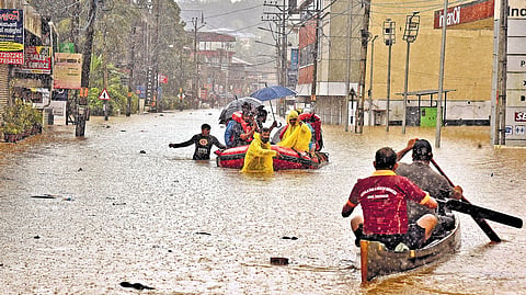 Fire and rescue services personnel evacuating residents stranded in flood-hit homes by boat in Ranni on Saturday.