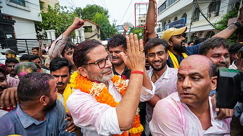 Jan Suraaj Party founder and candidate Prashant Kishor greets people during a march as he leads over BJP's Neeraj Kumar Sinha to 10,436 votes in the Bankipur assembly by-election