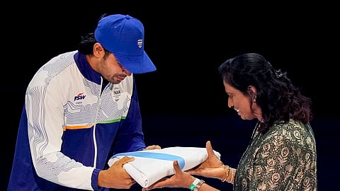 Glasgow: Indian javelin thrower Neeraj Chopra, left, hands over the Commonwealth Games Federation flag to Indian Olympic Association (IOA) President P T Usha during the closing ceremony of the 23rd Commonwealth Games (CWG), at OVO Hydro, in Glasgow, Scotland, Sunday, Aug. 2, 2026.