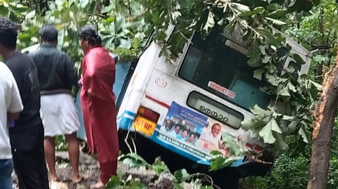 The bus reportedly rolled down the slope before getting wedged between trees, preventing it from plunging further and possibly averting a bigger tragedy.