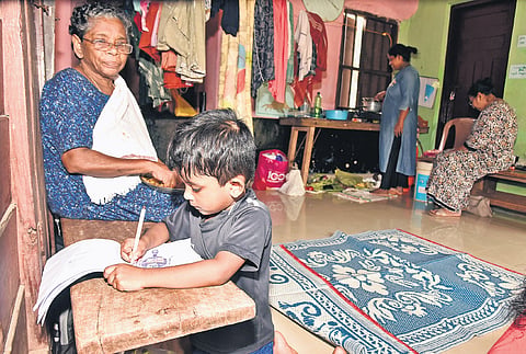 A child staying at the relief camp at a school in Kozhencherry spends time drawing, offering a glimpse of resilience amid the flood crisis.