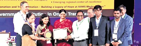 Union minister Anupriya Patel presenting the award to AIIMS-Bhubaneswar president Dr Anita Saxena in New Delhi on Monday