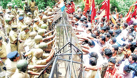 Police block a march by plantation workers at Konnappara near Konni.