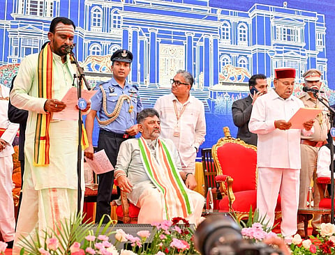 Kashappanavar Vijayananda Shivashankarappa during swearing-in ceremony of the new cabinet at Lokabhavana in Bengaluru on Monday Chief Minister D K Shiva Kumar and Governor Thawar chad Gehlot also seen