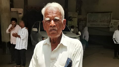 Farmer E Bakka Reddy showing his land papers at Sangareddy collectorate on Monday