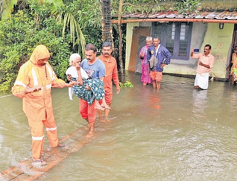 Elderly woman being evacuated to a safer location after floodwaters inundated houses at Veloor in Kottayam.