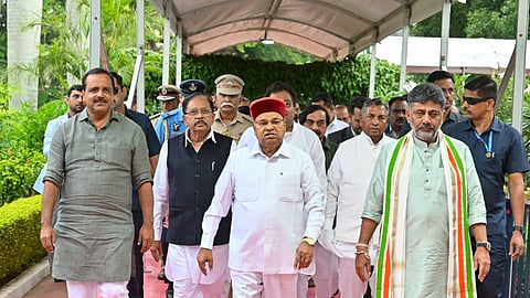 Governor Thaawarchand Gehlot, Chief Minister DK Shivakumar, Deputy CM Dr G Parameshwara, ministers UT Khader and KH Muniyappa and others arrive to attend the swearing-in ceremony of the new ministers in Bengaluru on Monday