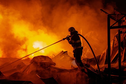 Firefighters put out a fire after Russian missiles hit a warehouse in Kyiv, Ukraine, Wednesday, Aug. 5, 2026