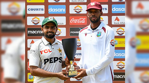 Chase and Babar receive the trophy and pose for the photographs.