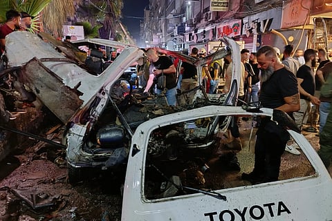 Syrian security personnel inspect damaged vehicles at the site of an explosion in the Jaramana suburb, home to a large Druze population, in Damascus, Syria, Thursday, Aug. 6, 2026.
