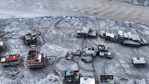 An aerial view shows damaged structures covered in thick mud and debris following the devastating flash floods at Devighat village, in Nuwakot district, Nepal, Friday, Aug. 28, 2026