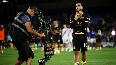 Manchester City's French midfielder #10 Rayan Cherki applauds the fans following the English Premier League football match between Crystal Palace and Manchester City at Selhurst Park in south London on August 28, 2026.