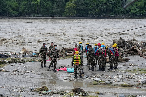 A Nepal Army official conduct a search and rescue operation along side a river area at Charaudi, in Dhading district, Nepal, Friday, Friday, Aug. 28, 2026.