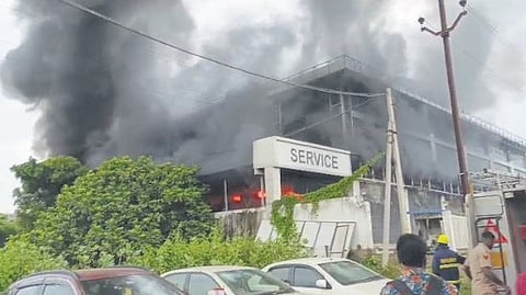 The car showroom engulfed in flames on the day.