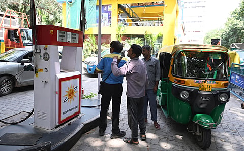 Commuters wait to fill up CNG at the IGL fuel station after CNG prices were hiked by Rs 3.89 per kg, in New Delhi on Saturday.