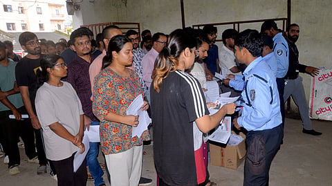 Students wait outside an examination centre before appearing in the NEET-PG 2026 examination, in Ranchi, Sunday, Aug. 30, 2026.