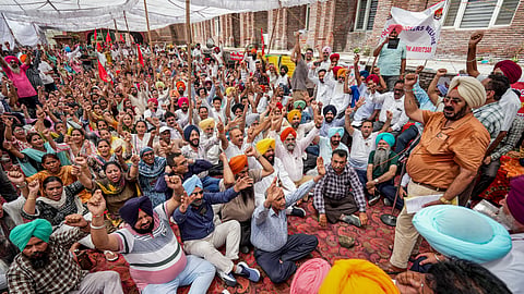 Government employees stage a statewide strike against the AAP government over their demands, including the release of pending dearness allowance, affecting functioning in various government departments and OPD services in hospitals, in Amritsar, Thursday, Aug. 27, 2026.